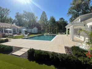 Outdoor living space with pool integrated into landscaped backyard